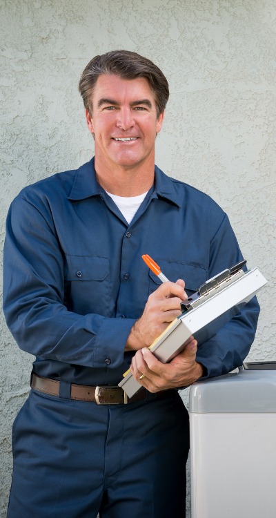 Technician Standing Next To Air Conditioner Holding Clipboard (3)