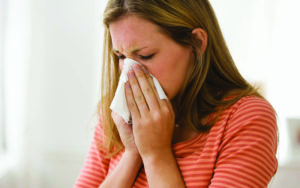 woman sneezing